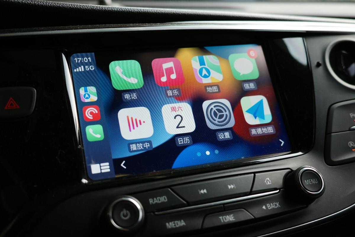 iPhone connected to the car's CarPlay system via a wired connection